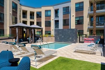 Resort-style oversized spa surrounded by custom seating and fire features